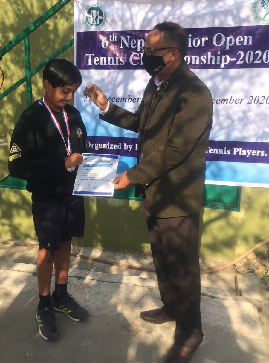 Abeer, Tennis Student, receiving his Diploma for second place in the 6th Nepal Junior Open Tennis Championship 2020.